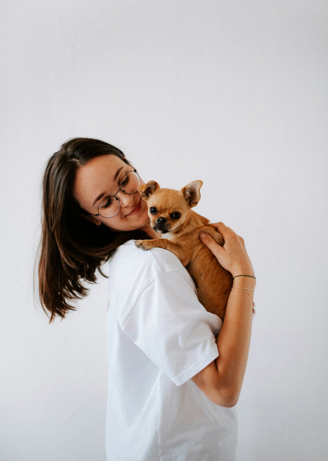 Veterinary technician holding a small dog